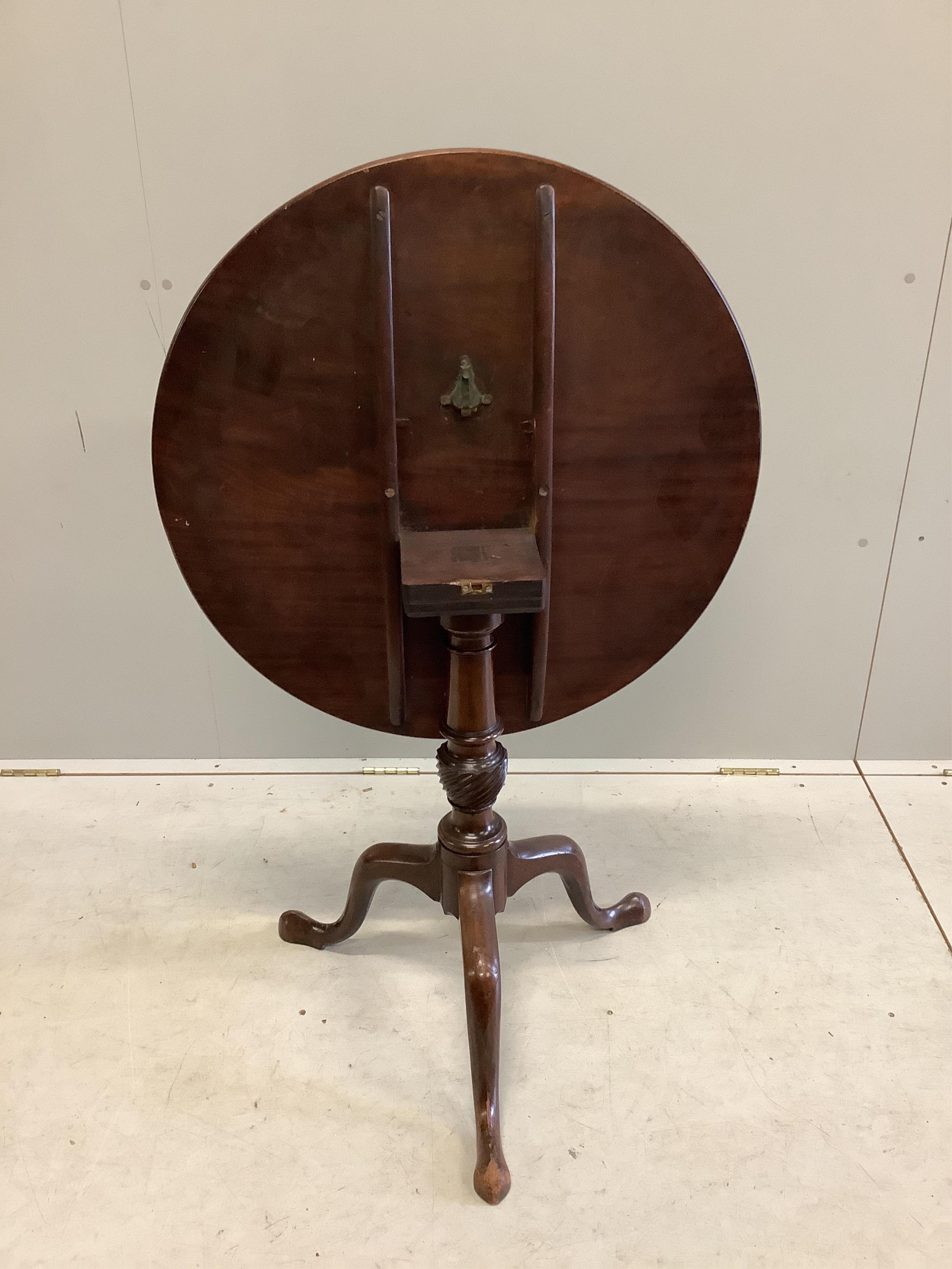 A George III mahogany circular tilt top tripod tea table, diameter 73cm, height 72cm. Condition - fair